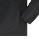 Close-up of a black shirt with a collar and sleeve on a white background
