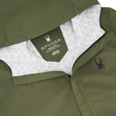 Close-up of a green jacket with Spyder logo on a white background
