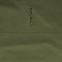 Close-up of a green fabric with 'Spyder' branding.