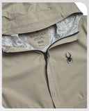 Close-up of a beige jacket with Spyder logo and brand tag.
