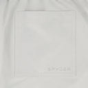 Close-up of a white jacket with 'Spyder' branding on a light gray background